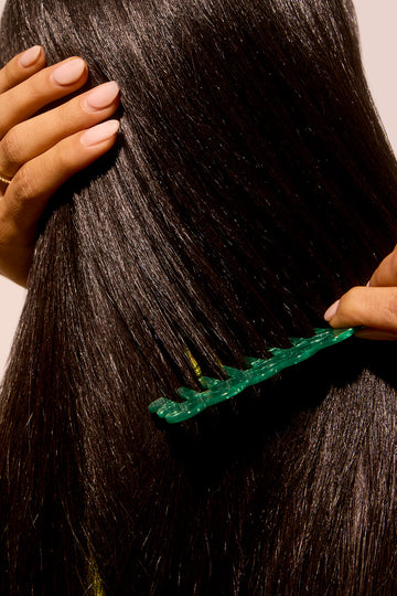 Woman combing her hydrated frizz-less hair